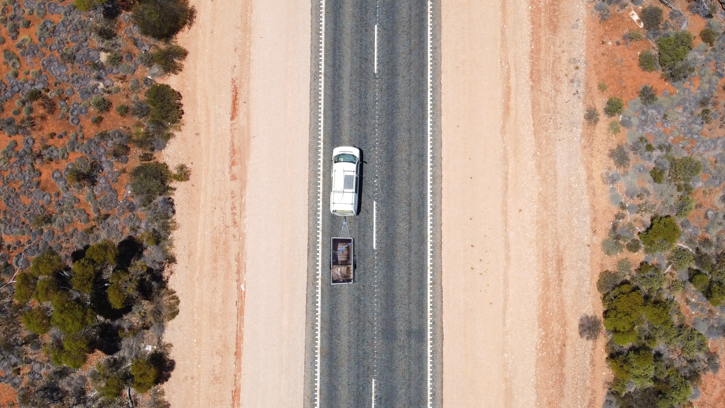 van barrels on a trailer crossing the desert